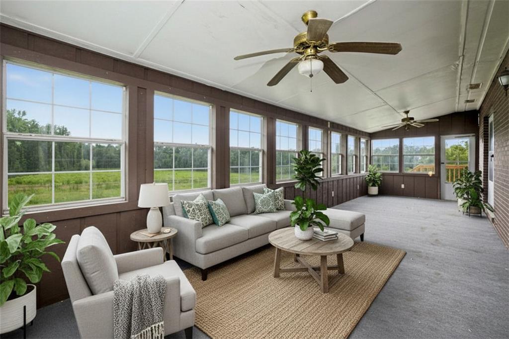 1605 Shackelford Road Griffin, GA 30224 - Photo 7 of 51 a living room with furniture ceiling fan and a large window