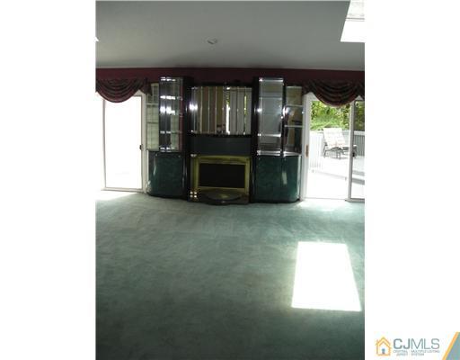 22 Evan Drive Morganville, NJ 07751 - Photo 5 of 14 a living room with furniture and a large window