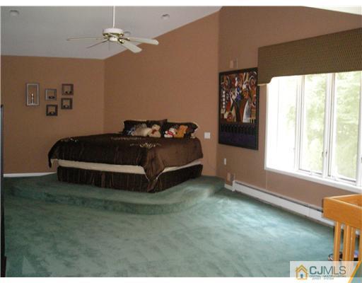 22 Evan Drive Morganville, NJ 07751 - Photo 8 of 14 a living room with a bed furniture and a window