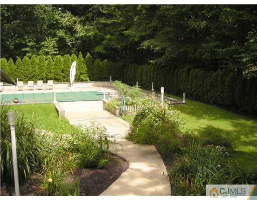 22 Evan Drive Morganville, NJ 07751 - Photo 9 of 14 a view of backyard with swimming pool