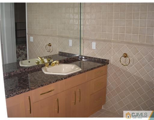 22 Evan Drive Morganville, NJ 07751 - Photo 10 of 14 a bathroom with a sink and a mirror