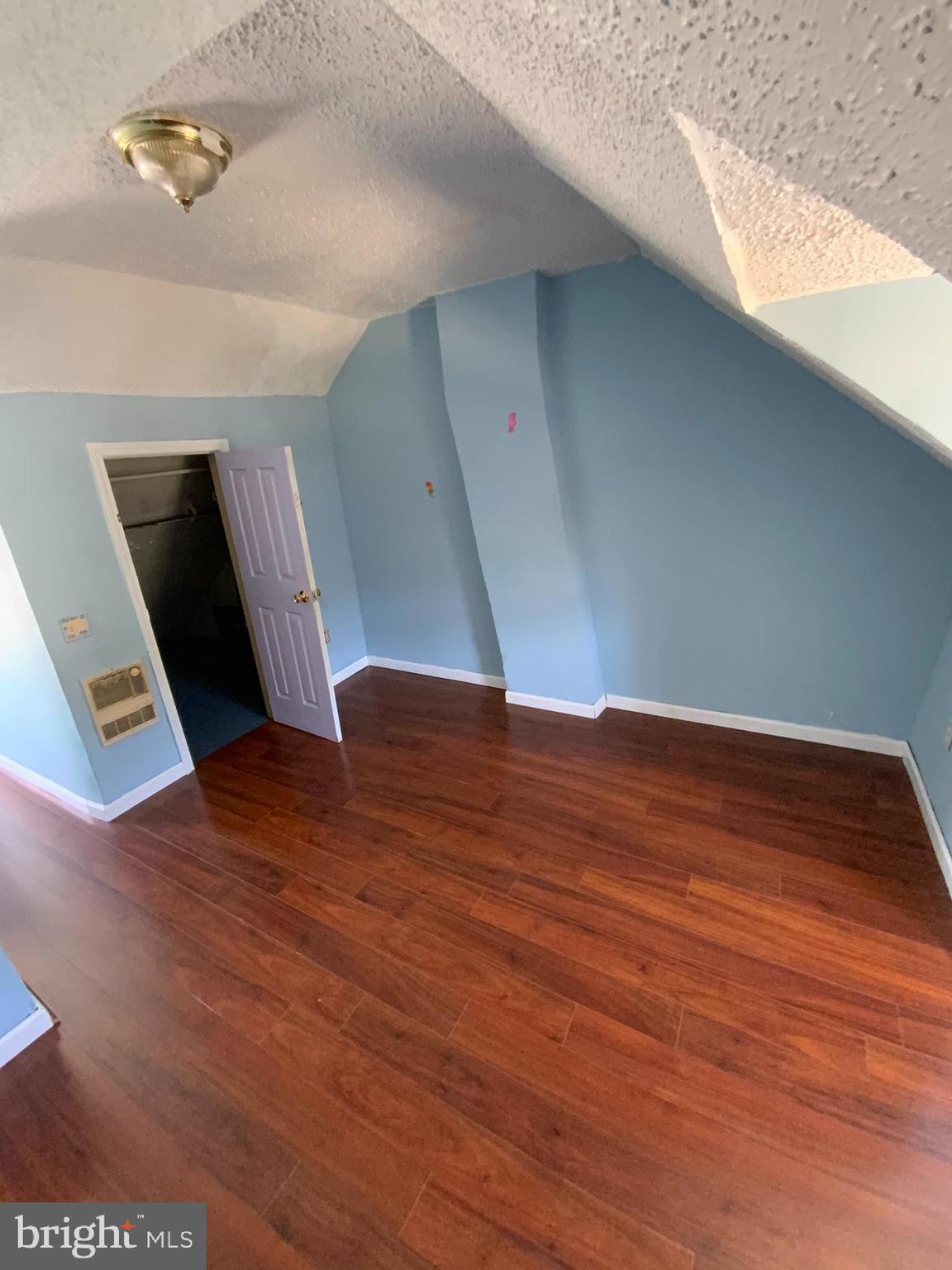 434 Birch Street Reading, PA 19604 - Photo 6 of 12 a view of an empty room with wooden floor and staircase