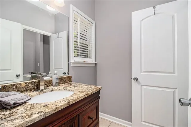 a view of an empty room and chandelier fan