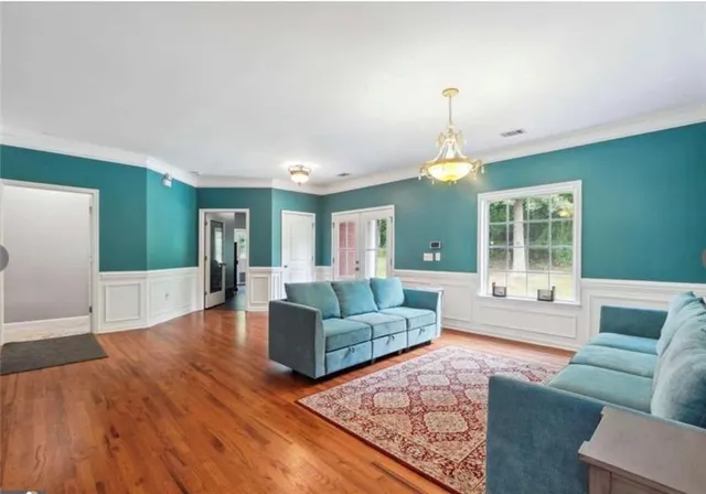 a living room with furniture and a chandelier