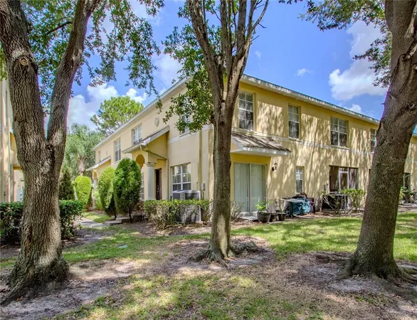 a view of a house with a tree in a yard