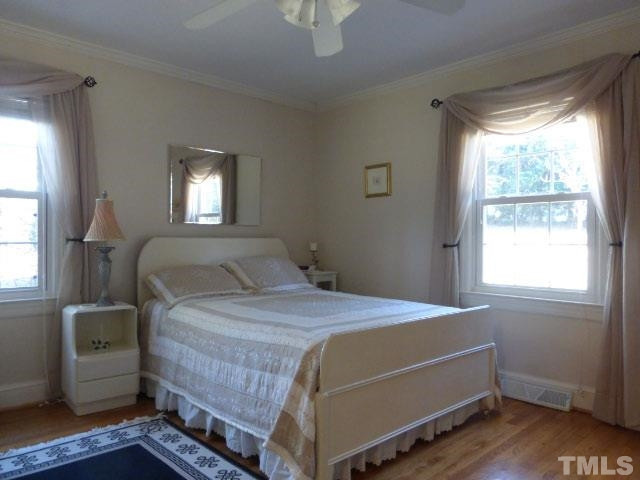 1216 Brookside Drive Raleigh, NC 27604 - Photo 14 of 24 The big back bedroom includes hardwood floors found throughout the house.