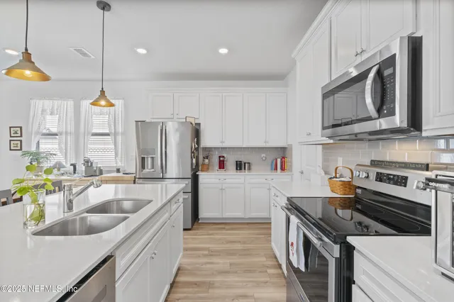 a bedroom with a bed and a flat tv screen on dresser