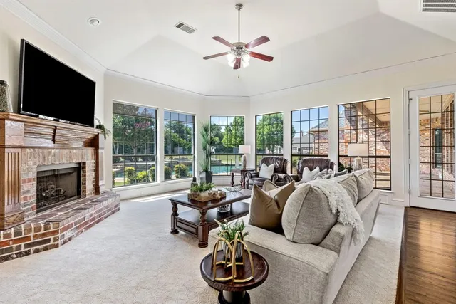 a living room with furniture large window and a flat screen tv