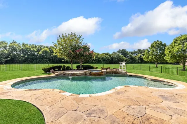 an aerial view of residential houses with outdoor space and trees