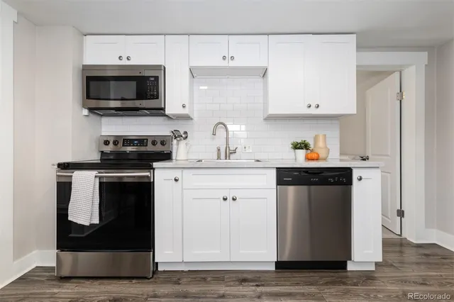 a kitchen with stainless steel appliances a stove a microwave and cabinets