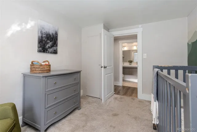 a room with a baby crib and a dresser