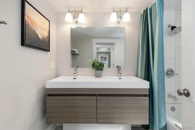 a bathroom with a sink vanity and a mirror