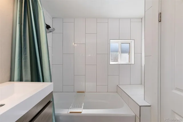 a bathroom with a bathtub and a sink