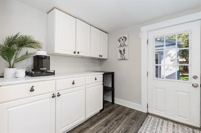 a kitchen with stainless steel appliances white cabinets and a window