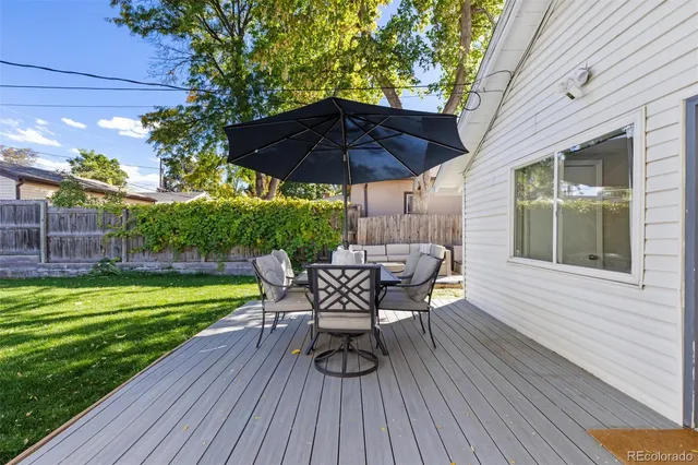 a view of a chair and table on the wooden deck