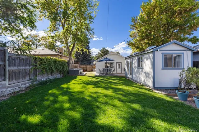 a front view of a house with yard and green space