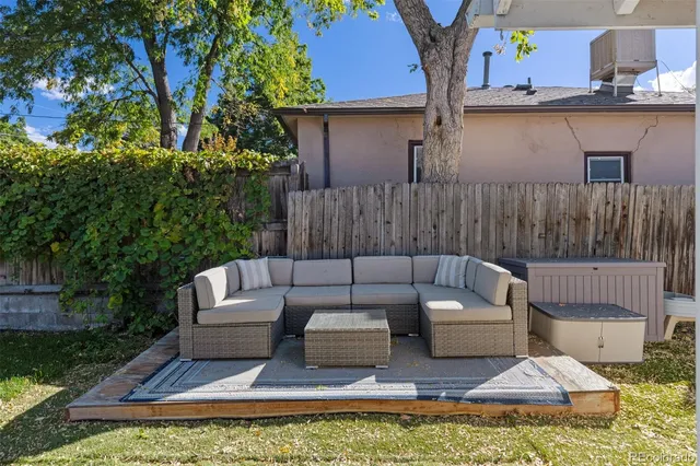 a view of a swimming pool with couches and lounge chairs