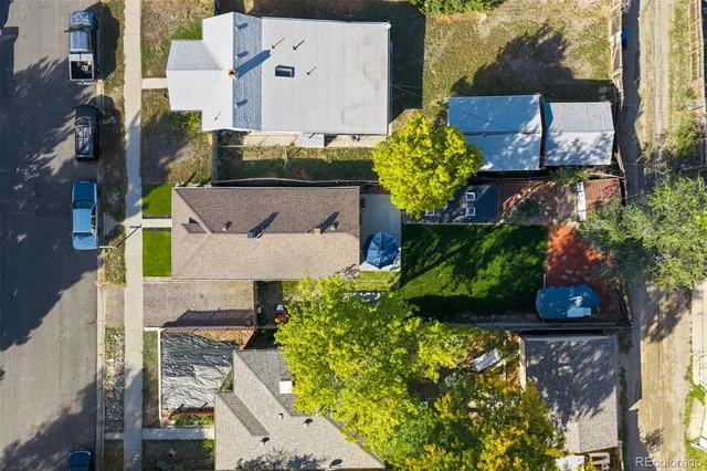 aerial view of a house with a yard and garden