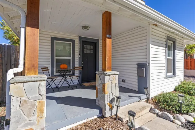 a view of a patio with table and chairs and potted plants