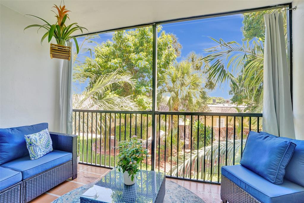 2350 Northeast 14th Street Causeway, Unit 203 Pompano Beach, FL 33062 - Photo 1 of 23 a living room with furniture and a potted plant