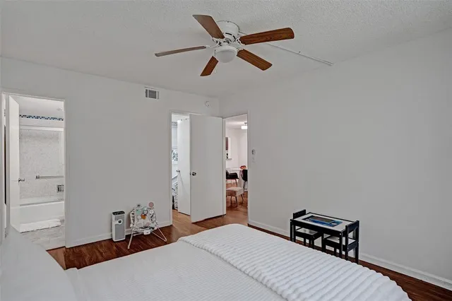 a bedroom with a bed and a ceiling fan