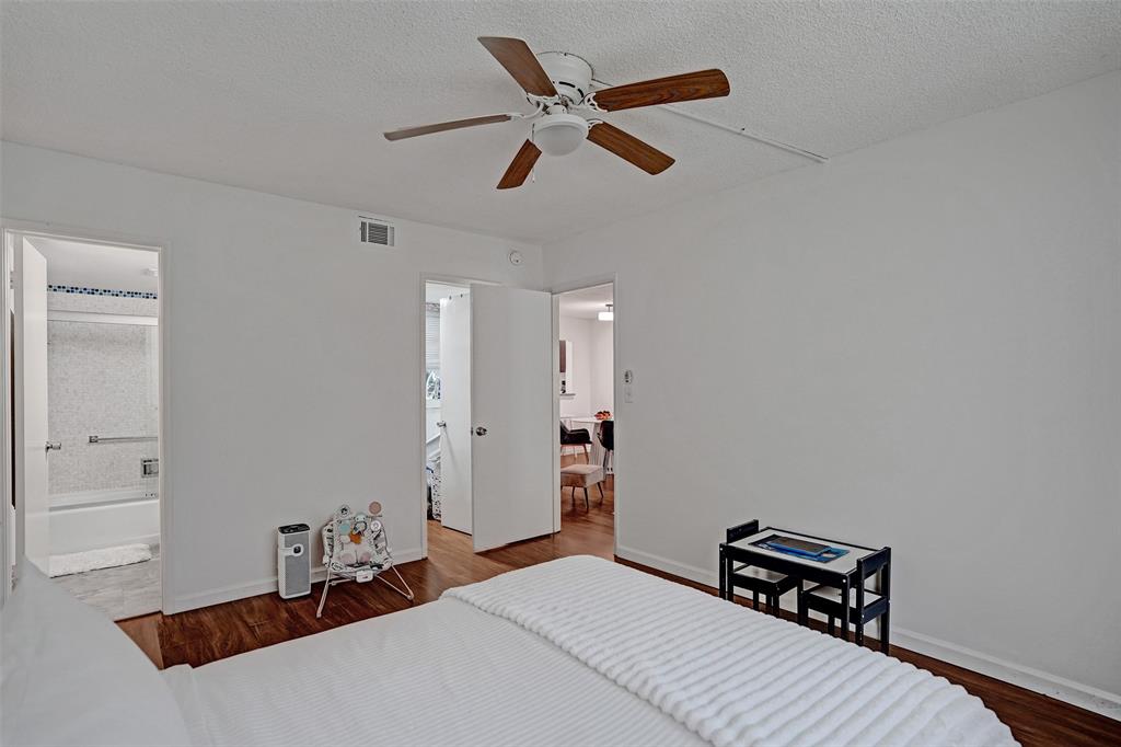 2350 Northeast 14th Street Causeway, Unit 203 Pompano Beach, FL 33062 - Photo 11 of 23 a bedroom with a bed and a ceiling fan