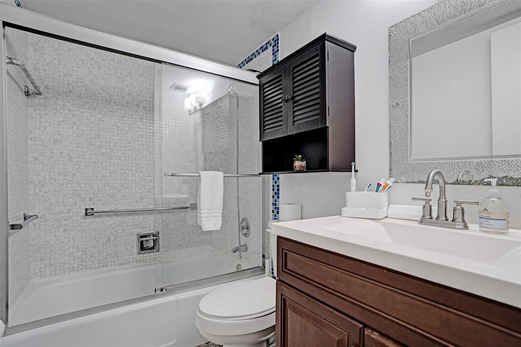 2350 Northeast 14th Street Causeway, Unit 203 Pompano Beach, FL 33062 - Photo 13 of 23 a bathroom with a sink a toilet and shower