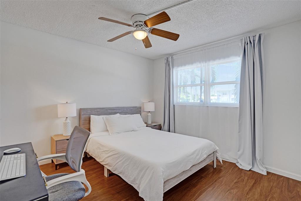 2350 Northeast 14th Street Causeway, Unit 203 Pompano Beach, FL 33062 - Photo 14 of 23 a bedroom with a bed and a window