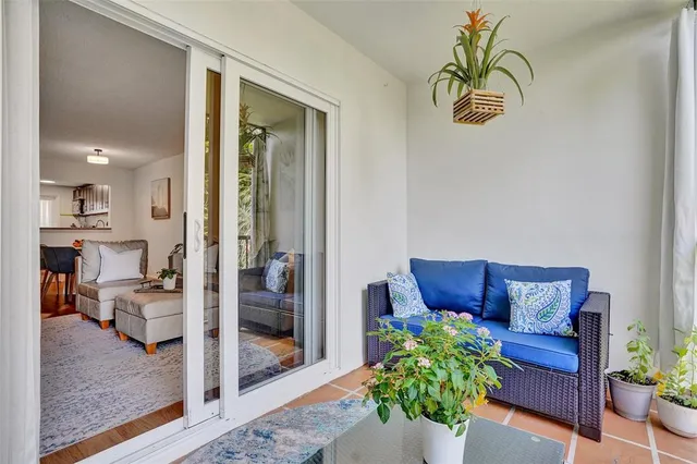 a living room with furniture and a potted plant