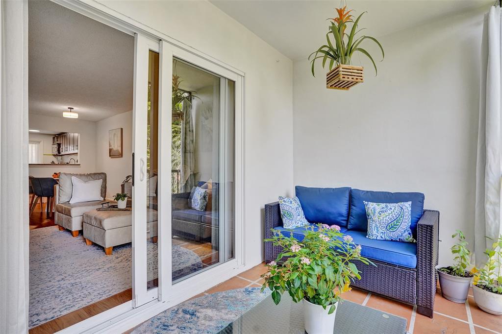2350 Northeast 14th Street Causeway, Unit 203 Pompano Beach, FL 33062 - Photo 18 of 23 a living room with furniture and a potted plant