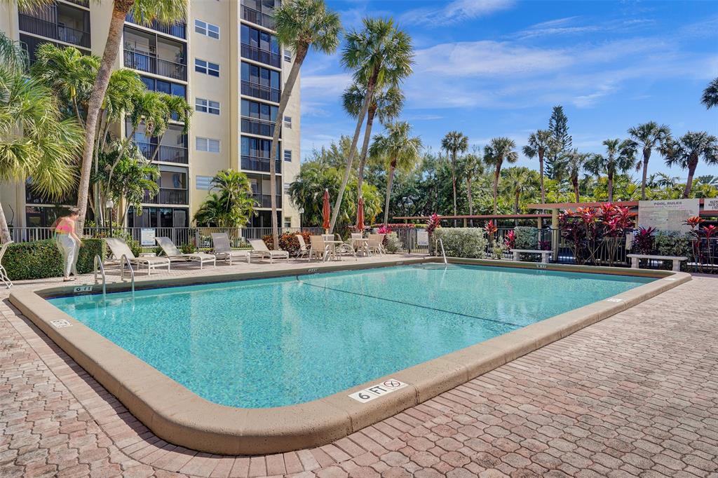 2350 Northeast 14th Street Causeway, Unit 203 Pompano Beach, FL 33062 - Photo 2 of 23 a view of a swimming pool with outdoor seating