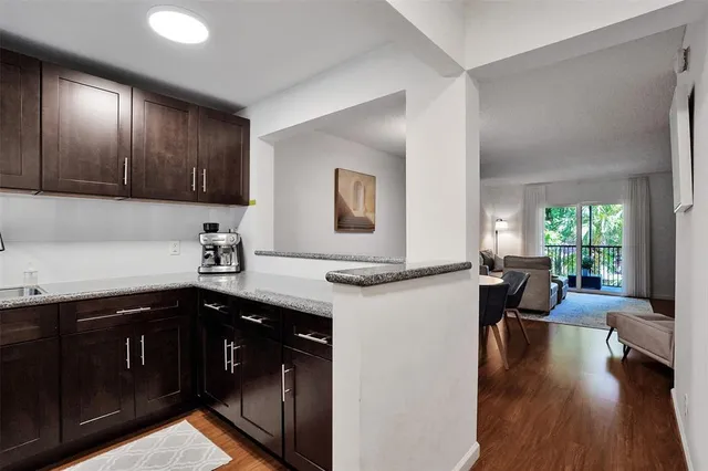 a kitchen with a sink dishwasher a stove and a refrigerator with wooden floor