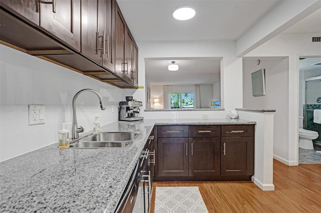 2350 Northeast 14th Street Causeway, Unit 203 Pompano Beach, FL 33062 - Photo 4 of 23 a kitchen with sink and mirror