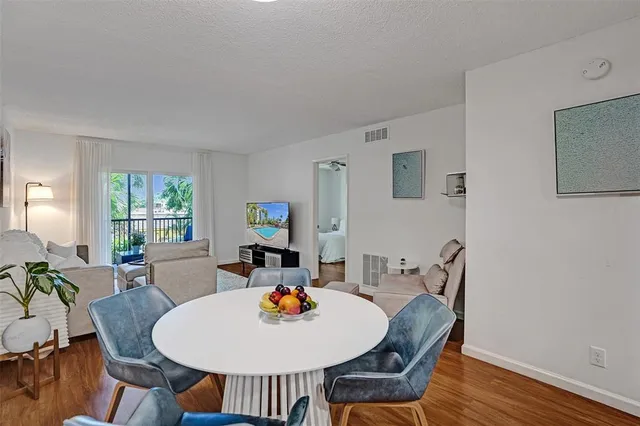 a dining room with furniture a window and wooden floor