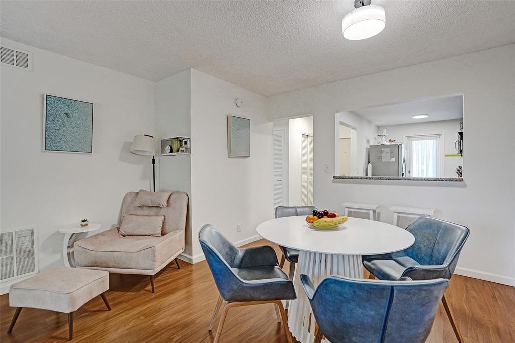2350 Northeast 14th Street Causeway, Unit 203 Pompano Beach, FL 33062 - Photo 6 of 23 a view of a dining room with furniture and wooden floor