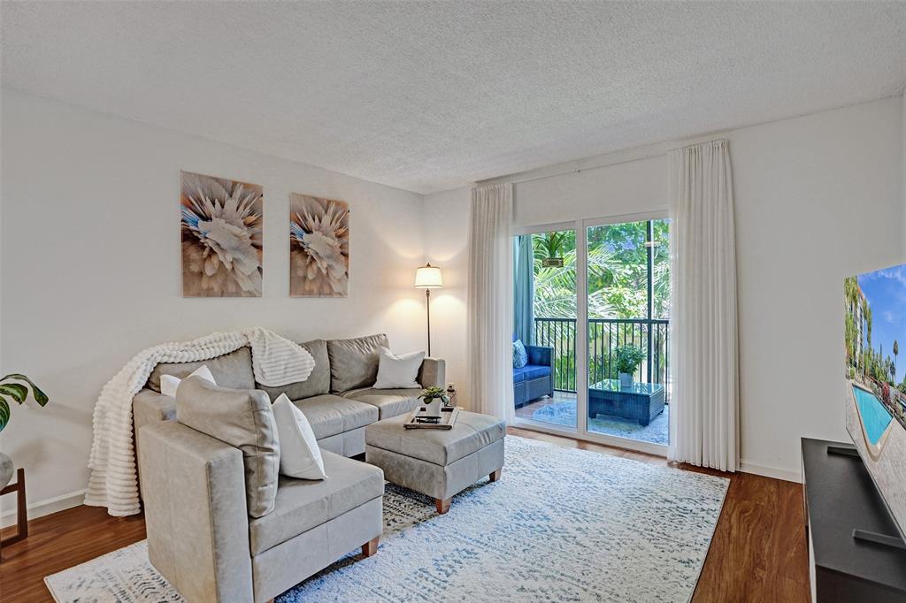 2350 Northeast 14th Street Causeway, Unit 203 Pompano Beach, FL 33062 - Photo 7 of 23 a living room with furniture and a large window