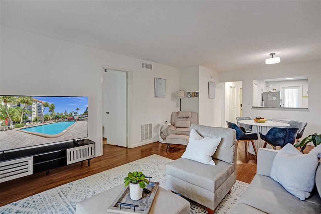 2350 Northeast 14th Street Causeway, Unit 203 Pompano Beach, FL 33062 - Photo 9 of 23 a living room with furniture and a flat screen tv