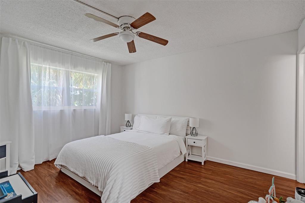 2350 Northeast 14th Street Causeway, Unit 203 Pompano Beach, FL 33062 - Photo 10 of 23 a bedroom with a bed and a window