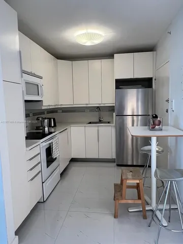 a kitchen with cabinets stainless steel appliances and a sink