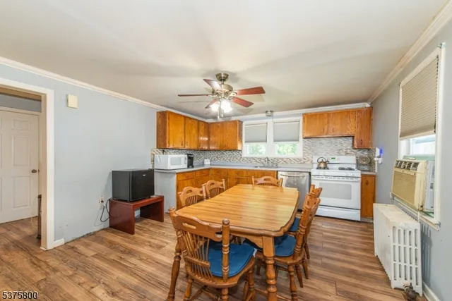 a view of a dining room with furniture and a kitchen