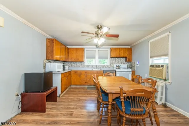a view of a dining room with furniture and wooden floor