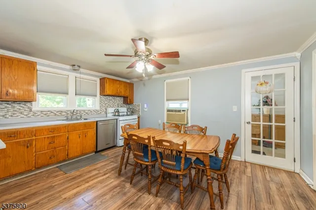 a view of a dining room with furniture window and wooden floor