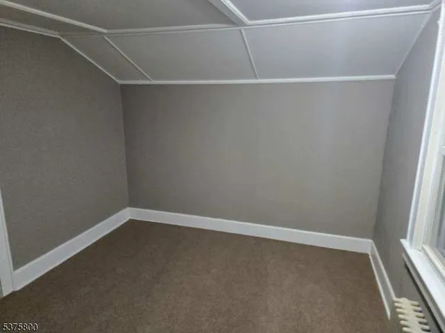 a view of house with wooden deck and furniture