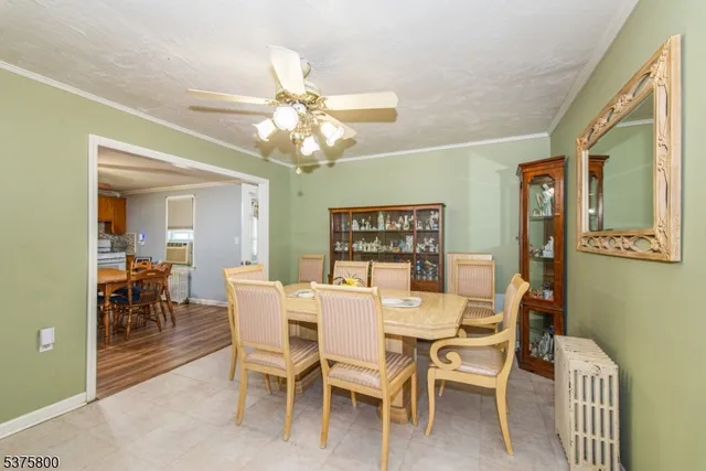 a view of a dining room with furniture and chandelier