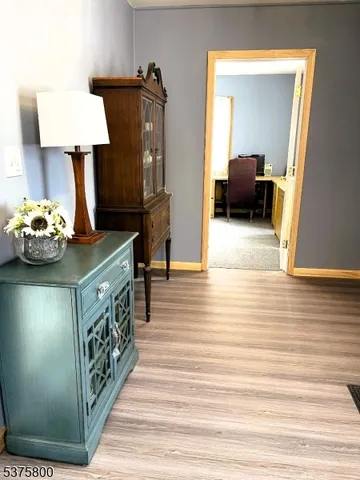 a view of living room with furniture and a lamp