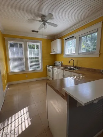 a view of a kitchen counter top space a sink and appliances