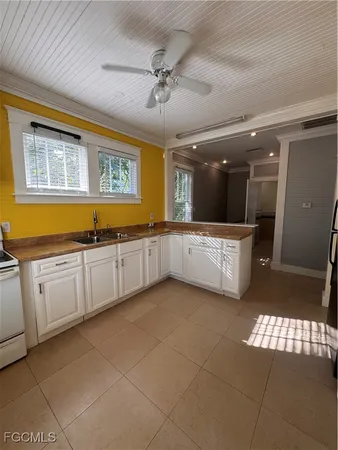 a large kitchen with stainless steel appliances granite countertop a sink and cabinets
