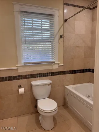 a bathroom with a toilet a sink and bathtub