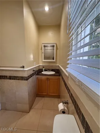 a kitchen with a sink a stove top oven and cabinetry