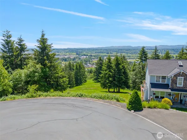 an aerial view of a house with a yard and lake view